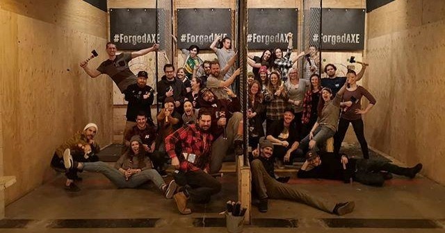 A group of people posing for a picture during the axe throwing league