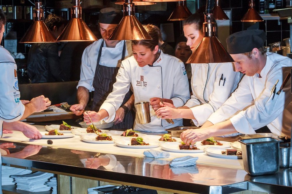 a group of people preparing food on a table